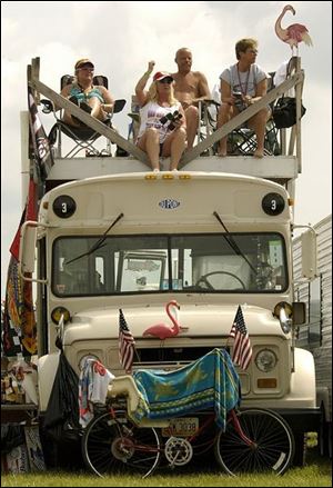 For NASCAR fans it doesn't get any better than this: a rooftop vantage point to spend time with friends and watch the racing. From left are Barb Brown, Rosi Thompson, Rick Ayers and Shar Gamo. They'll be back atop Ayers' bus today for the Sirius 400.