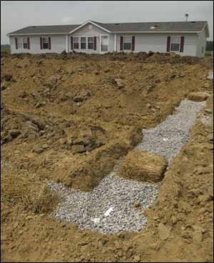Tons of sand and stone are required for the leach field.