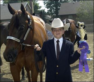 Jacob Hermiller, 11, is all smiles, after winning his junior horsemanship ribbon and trophy at the Putnam County Fair. The fair, one of the first of the season, opened yesterday in Ottawa.