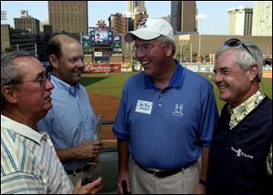 From left, Tom Meeks and Mike Davis of the U.S. Golf Association chat with Marc Stockwell of Inverness Club and U.S. Senior Open golfer Jay Overton at Fifth Third Field.

