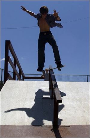 Richard Ruby rides the rail during practice for the intermediate division of competition at Parmalee Park.
