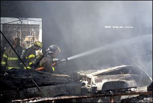 Firefighters try to douse the flames at an abandoned apartment building. 