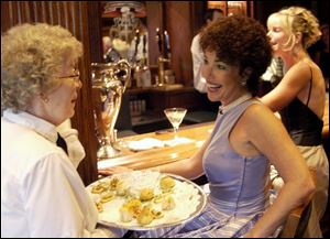 BAR TIME: Joni Arredia flashes her smile in the men's locker room bar.