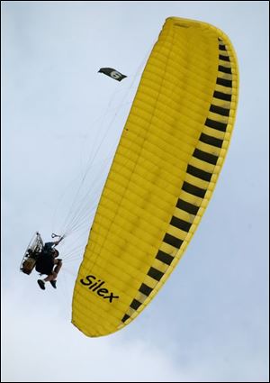 Wally Shilts of New Paris, Ohio, prepares to land at Ohio's annual Motorized Paragliding Gathering in Perrysburg.