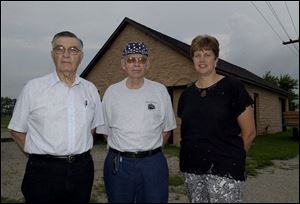 `We have the plan. All we need is the permission to go ahead with it,' says Kirk Hise, center, a retired railroad worker, who has joined with Charlie Sheets, president of the Waterfront Electric Railway Museum, and Ellen Bergman to save the old Genoa trolley depot, which is behind them.