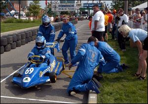 TIME FOR A CHANGE: McElheney Locksmith's car No. 69 pulls into pit row for a switch of drivers and a tire.