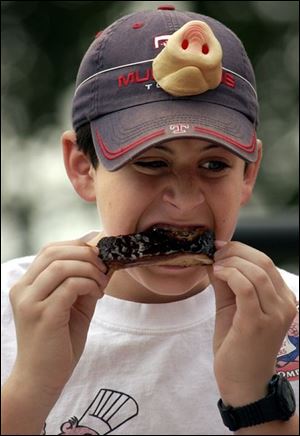 Neil Weinberg, 13, tries some of the event's offerings.