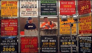 Tom Sopavich, left, and Cliff Mortimer, representing Armadillo's Restaurant of Youngstown, cook up a slab of ribs.