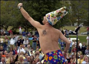 Tim Goldreiner, lead singer of the Menus, cranks up the crowd at Promenade Park last night as part of Toledo's Labor Day weekend, including fireworks and today's parade.