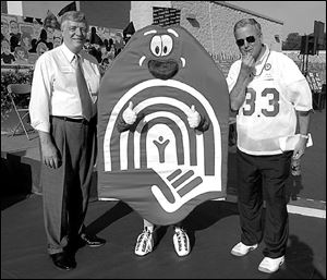 Dan Johnson, left, and Bill Block, Jr., with the United Way's mascot, Uwie, at the group's campaign kick-off.