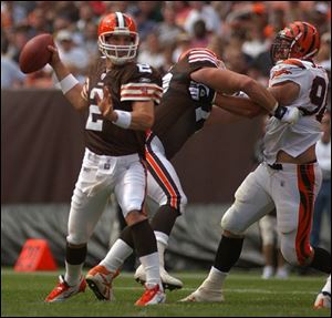 An offensive lineman protects Cleveland quarterback Tim Couch as he stands in the pocket. Couch completed 23 of 36 passes for 280 yards and two touchdowns.