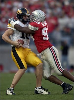 Ohio State's Will Smith sacks Iowa quarterback Nathan Chandler, who was 14-of-27 for 153 yards with an interception.