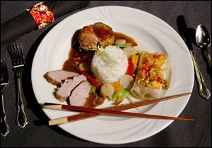A trio of Asian-inspired entrees will be served at the ball. Clockwise from top, Beef Fillet with Soy Mustard Glaze, Salmon in Crisp Rice Paper, and Sliced Duck Breast with Zinfandel Sauce.