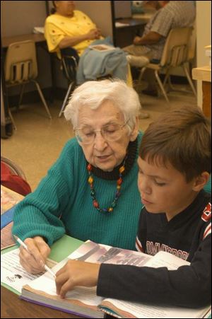 `I find it very rewarding to help the children with their studies,' says Irene Klocinski, with Christopher Sutton, 9.
