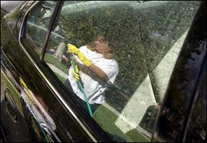 ROV CAR WASH 10/23/03 PHOTO BY LORI KING Toledoan Jennifer Johnson was going to wash her car at a car wash but decided the day wasn't as cold as she thought, as long was the sun was shining, so she washed it in her Ogden Ave. driveway.
