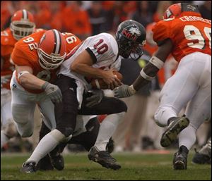 Bowling Green's Brad Williams, left, and Mitchell Crossley wrap up Northern Illinois QB Josh Haldi. Crossley is the second-leading sack man in the MAC with 8 in 8 games.