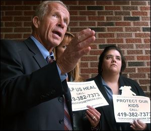 Attorney Jeff Anderson, Barbara Blaine, and Claudia Vercellotti, from left, discuss the lawsuit filed yesterday during a news conference in front of the Catholic diocese's offices.