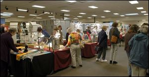 Viewers crowd the exhibits at the Southview art show, which helps fund after-prom activities.