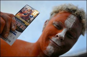 Steve Anderson, a Cleveland Browns fan from Toledo, holds a ticket displaying his likeness. He wore the same face paint yesterday as when the photo was taken.