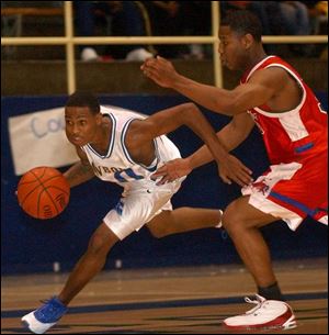 Libbey's Eugene Harris (12 points) drives past St. Francis defender C.J. Johnson. 