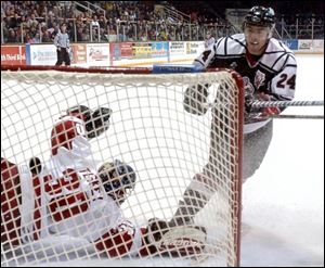 Trenton s Mathieu Brunelle watches his puck settle into the back of the net past a diving Storm goaltender Doug Teskey, giving the Titans a 4-0 lead in the second period.