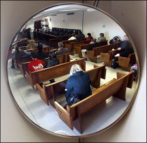Defendants waiting for their cases to be called and spectators wait in the pews of the often crowded Defiance Municipal Court.
