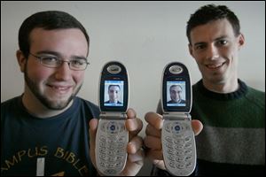 University of Toledo roommates Ryan Reedy, left, and Martin Gray, show each other s image on their camera cell phones, an example of their use for just fun.