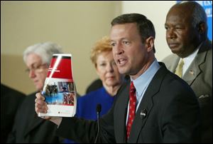 Baltimore Mayor Martin O Malley, holding a copy of a report tracking homeland security funds to the states, says the cities  money has been tied up in knots for too long.