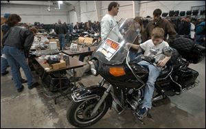 cty swap25p 3 January 25, 2004. Ryan Fereza, 10, of Toledo sits on his dad's 1982 Honda Gold Wing during the motorcycle swap meet at the Lucas County Recreation Center Sunday. Blade photo by Jeremy Wadsworth