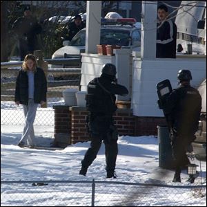 CTY STANDOFF31P 1 31/04 PHOTO BY LORI KING A woman is released from the a home on Oak Grove while the man who supposedly held her hostage stands on the porch prior to being taken peacefully into custody by law enforcement officials.