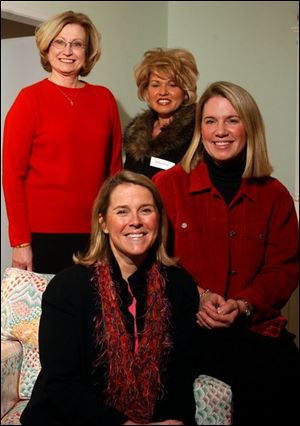 GREEN AND BEAR IT: Clockwise from left, Lacey Young, Laura Baird, Becky Hauck, and Lisa Silverman are the co-chairmen of the ticket committee for the Green Bear Ball that will benefit the Ottawa Hills school system.