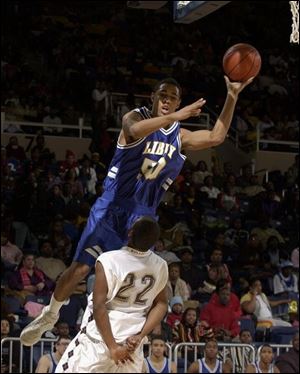 Libbey s Quintin Mitchell takes it to the basket aggressively against Scott defender Romeo Alexander last night at Savage Hall. Mitchell scored 10 points while Alexander had nine on 4-of-23 shooting.