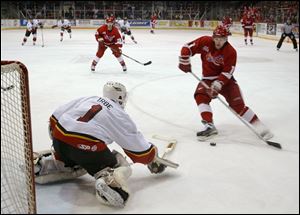 Johnstown goalie Arturs Irbe blocks a point-blank shot by Jim Abbott, but Rick Judson (center) scored on the rebound.