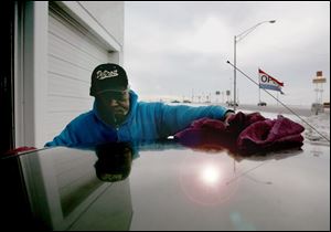 ROV dry 01 - J. LaBanks, reys off a car at the Cruisin car wash on Woodville Rd. as he enjoys the slightly warmer weather, before tonights predicted ice. Allan Detrich/The Blade