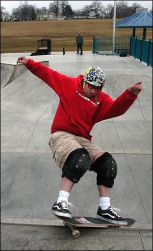 Rov Photo by Don Simmons Mar 3, 2004  Toddo Swalla  enjoys the new skatebroad park at Highland Park.  In the background is friend Rob LeBarr who also was testing his skills on a skatebroad