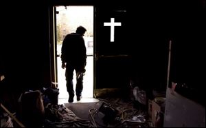 ROV Church Work  March 2, 2004-- A construction worker heads out of St. Joseph's Catholic church after finishing up some work Tuesday. The church at Erie and Locust streets is undergoing renovations. Blade photo by Andy Morrison