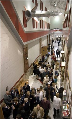 District residents walk the halls of the new school during an open house and dedication ceremony yesterday. The Ohio School Facilities Commission paid for 74 percent of the cost of the project.