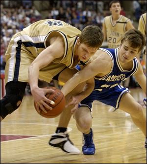 St. John's Zach Hillesland scraps with Hamilton's Casey Brooke. Hillesland finished with 11 points and 7 rebounds.
