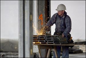 ROV hospconst 01 - A worker cut metal studs to form walls for the new Bellevue Hospital which is being built on the West side of Bellevue, this will replace the old one when construction is completed. Allan Detrich/The Blade