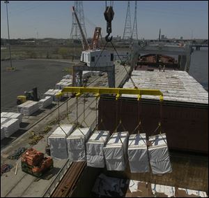 Rov lumber is unloaded from  the M.V. Menominee - the first foriegn ship to visit Toledo.  blade photo by herral long 4/14/2004