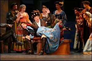 Kate (Emily Herring) undergoes a bit of behavior modification at the hand of Petruchio (Ryan Cutlip) in <i>Kiss Me, Kate</i>.