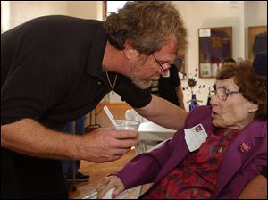Chip Davis of the group Mannheim Steamroller talks with Elizabeth 'Mrs. B.' Boomgarden, his first-grade teacher, during his visit to Hamler. She recalls that Mr. Davis was 'a good pupil.'