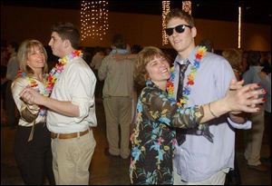 MOTHER-SON DANCE: From left, Deb Sanders and her son Zach dance as Marianne and Duke Keller have their own special moment at the St. John's Mom Prom.