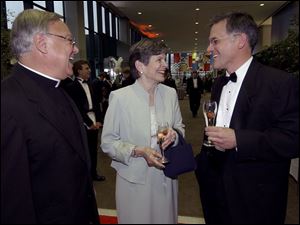 CLASS ACTS: Rev. Don Vettese, left, Mary Jo Anderson, and Dean Ludwig share a laugh at the St. John's Jesuit High School fund-raiser at One SeaGate.
