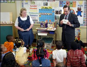 Gov. Bob Taft spends quality reading time with Anita LaLonde's kindergarten class at Sherman Elementary School in Toledo. The governor promoted reading as a tool for success.