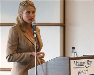 Model Kim Alexis talks to representatives of the Lifestyles for Ladies Only gym at a meeting in Maumee Bay State Park.