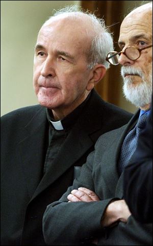 The Rev. Gerald Robinson and attorney Alan Konop listen to Judge Patrick Foley at Father Robinson's court appearance.