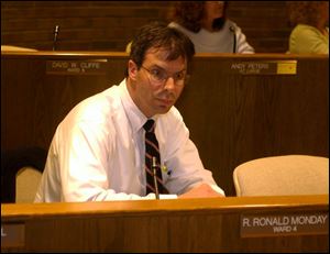 Councilman David Cliffe presides at the committee hearing in which he said news cameras would have to leave.