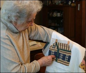Genevieve Eicher explains a quilting code that was used to pass information on to runaway slaves. The wavy lines represent Lake Erie while the two chimneys are Sandusky and Toledo. 