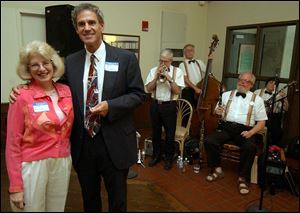 ALL THAT JAZZ: Suzi and Larry Michaels listen to the Cake Walkin' Jass Band add a bit of New Orleans flair to the atmosphere of the Historic Weber Block Building.